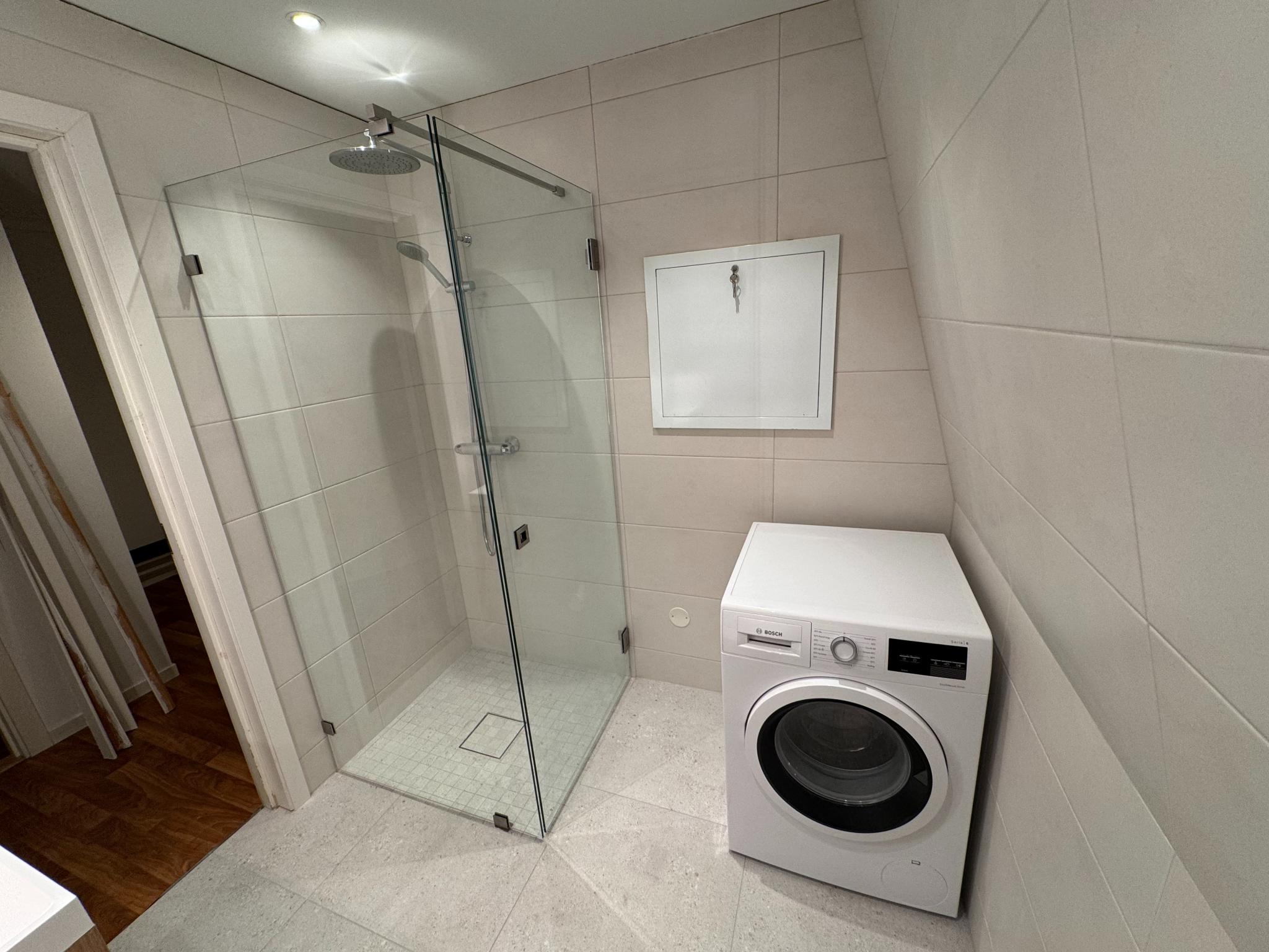 Nyoppusset bad, dusjhjørne og vaskemaskin